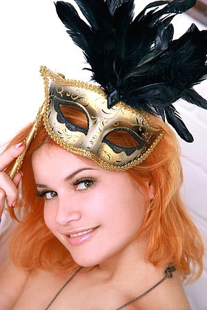 Redhead takes off her carnival mask along with the rest of her outfit